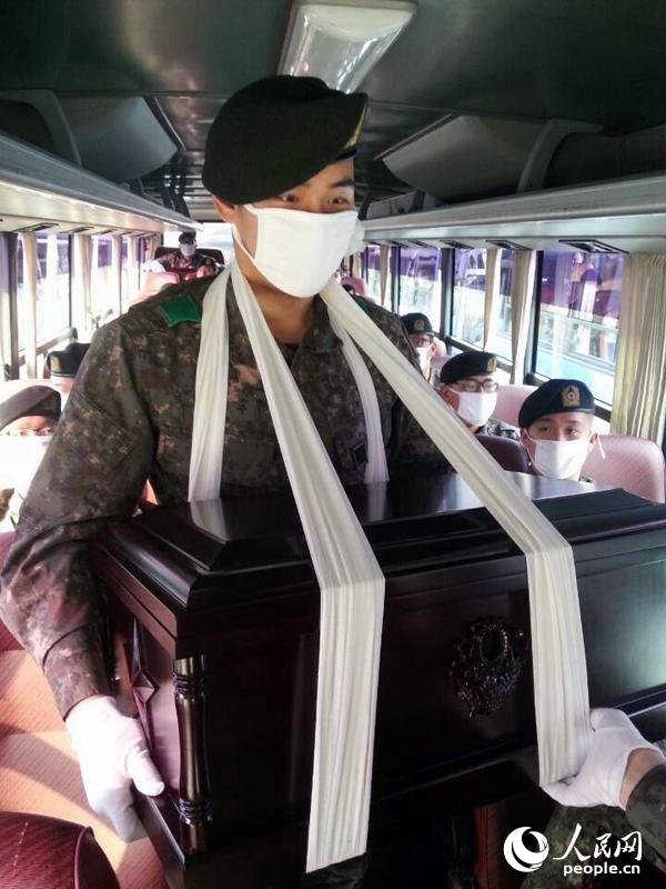 圖為韓國軍人手捧棺木。（人民網 張悅攝）