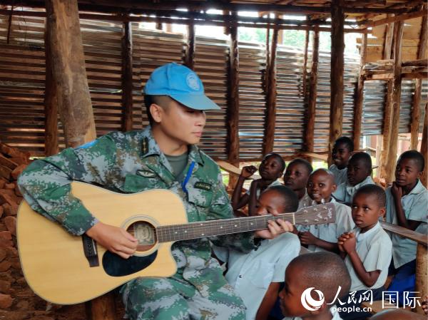 吉它弹唱教孩子们学唱中国歌曲（王玺 摄）