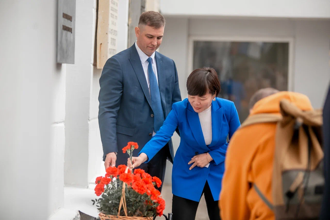 刘庆华（中）向纪念牌献花。家组俄罗斯阿尔希波夫基金会供图