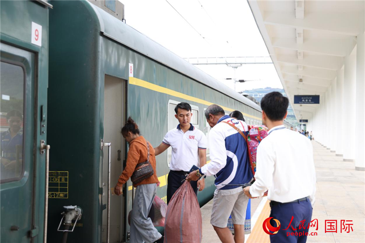 在中老铁路纳磨站，列车员引导旅客有序上车。人民网记者 杨一摄