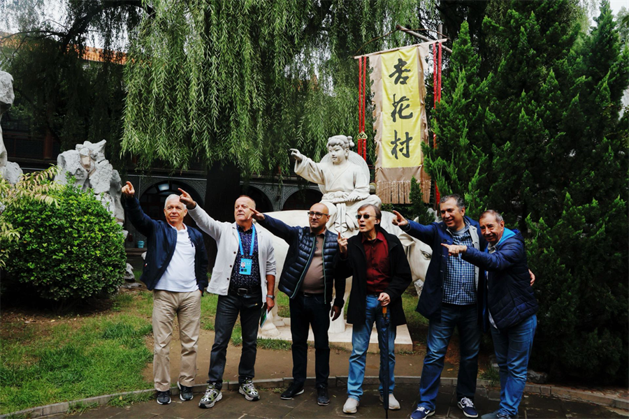 外国嘉宾在“牧童遥指杏花村”雕塑前，一起学牧童做手势。张赫摄