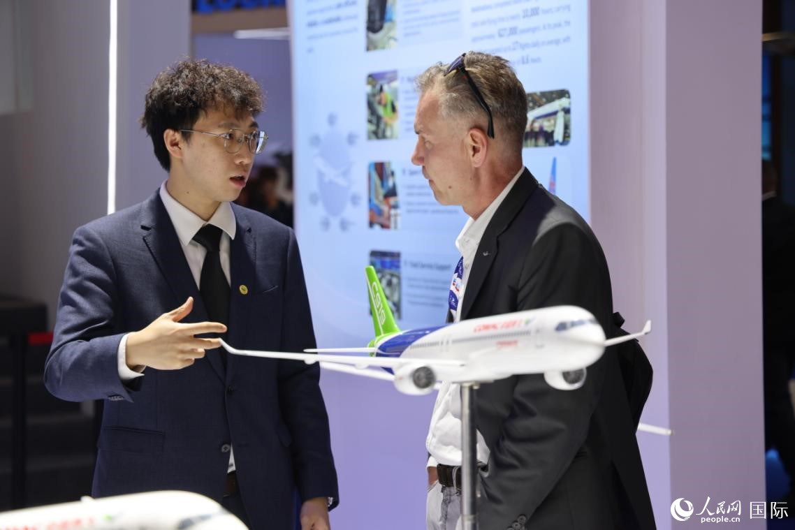 在中国商飞展台，工作人员向来宾进行介绍。人民网记者 张志文摄