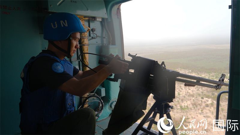 (3)图说:维和官兵正在执行空中武装巡逻,巡视地面可疑迹象 黄浩摄