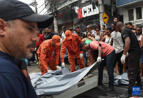 10月29日，在巴西里约热内卢的佩尼亚社区，救援人员将被击毙的犯罪嫌疑人遗体运离。新华社发（克劳迪娅·马尔提尼摄）