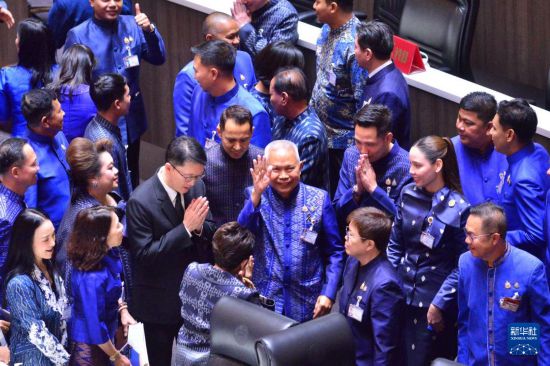 　　3月15日，泰国自豪泰党议员梭蓬·乍兰（中）在曼谷国会下议院庆祝当选。新华社发（拉亨摄）